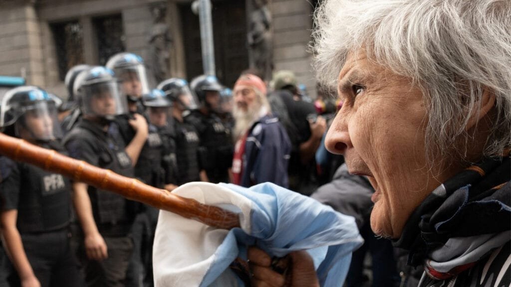 Señora jubilada enfrenta policías durante la represión en el Congreso.